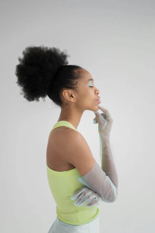 a woman in white gloves and a yellow top, trending on cg society, afrofuturism, curly messy high bun hairstyle, translucent neon, on grey background, metallic cyan bodysuit