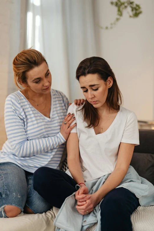 a couple of women sitting on top of a bed, trending on pexels, crying and reaching with her arm, medical image, ios, clinical