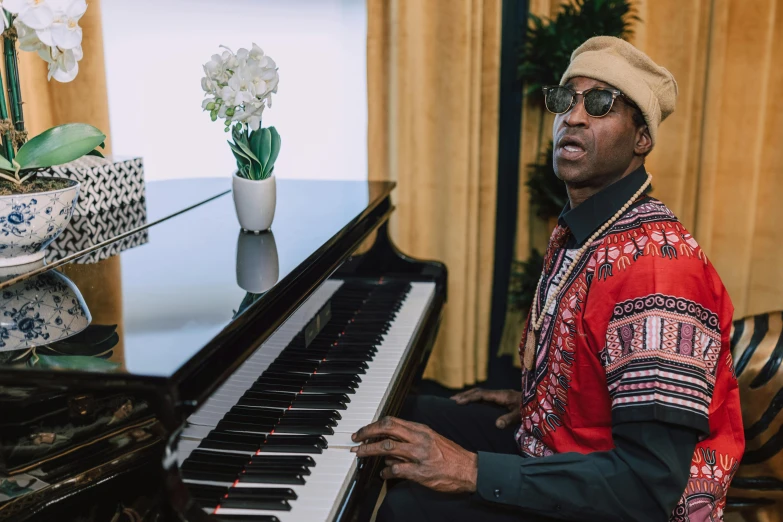 a man sitting at a piano in a living room, inspired by Michael Ray Charles, lance reddick, 2 chainz, press shot, performance