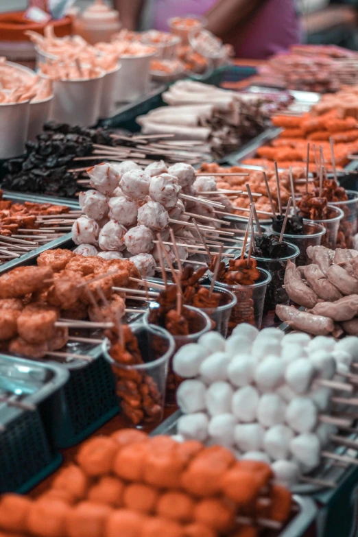 a table topped with lots of different types of food, street market, skewer, 2019 trending photo, thumbnail