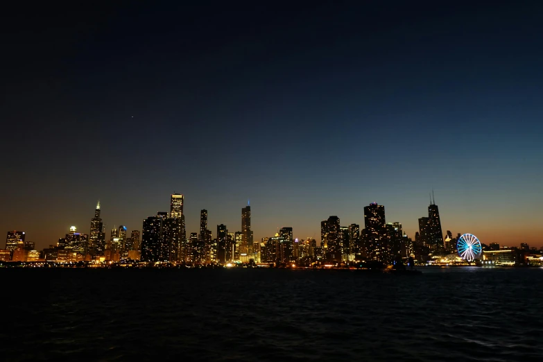 a large body of water with a city in the background, by Andrew Domachowski, pexels contest winner, on a clear night sky, chicago skyline, early evening, 2 0 2 2 photo