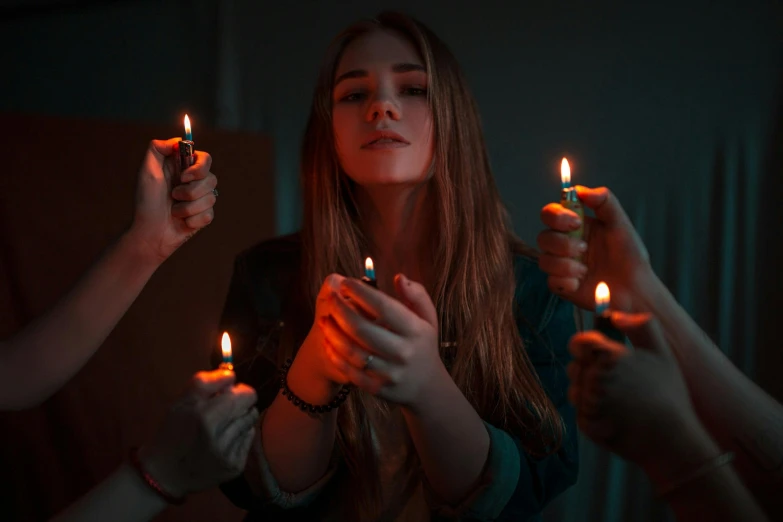 a group of people holding lit candles in their hands, an album cover, inspired by Elsa Bleda, pexels contest winner, attractive girl, teenage girl, instagram post, dark photo