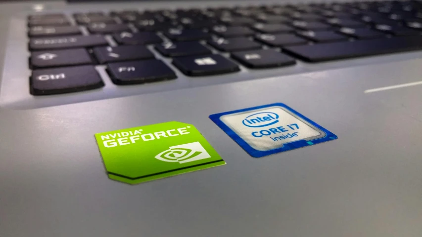 a close up of a laptop with a green sticker on it, a computer rendering, by Ryan Pancoast, pexels, nvidia geforce, a cpu with human brains, green and blue, keyboards