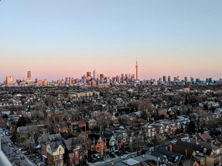 a view of a city from the top of a building, by Carey Morris, pexels contest winner, happening, toronto, clear skies in the distance, pink golden hour, drone photograph