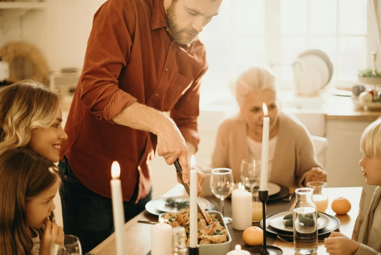 a man serving food to a group of people at a dinner table, on a candle holder, abcdefghijklmnopqrstuvwxyz, holiday season, thumbnail