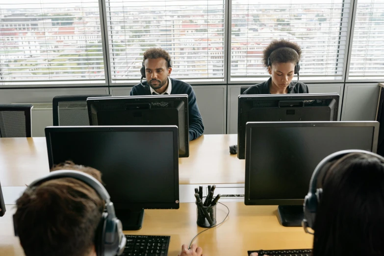 a group of people sitting at a table with computers, floating headsets, profile image, 9 9 designs, unedited