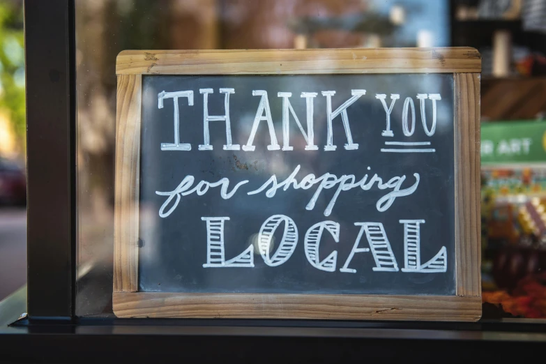 a sign that says thank you for shopping local, pexels contest winner, no cropping, blackboard, low quality photo, shopwindows