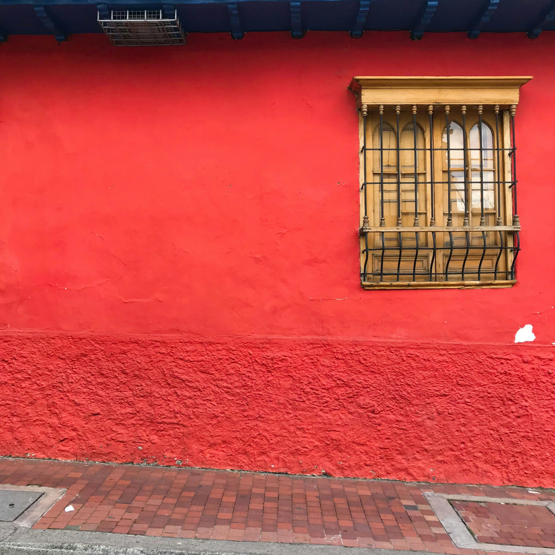 a fire hydrant in front of a red building, by Gina Pellón, pexels contest winner, postminimalism, colombia, windows and walls :5, before a stucco wall, gold and red