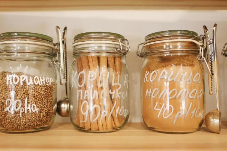 a close up of jars of food on a shelf, swedish writing, cinnamon, detailed product image, brown