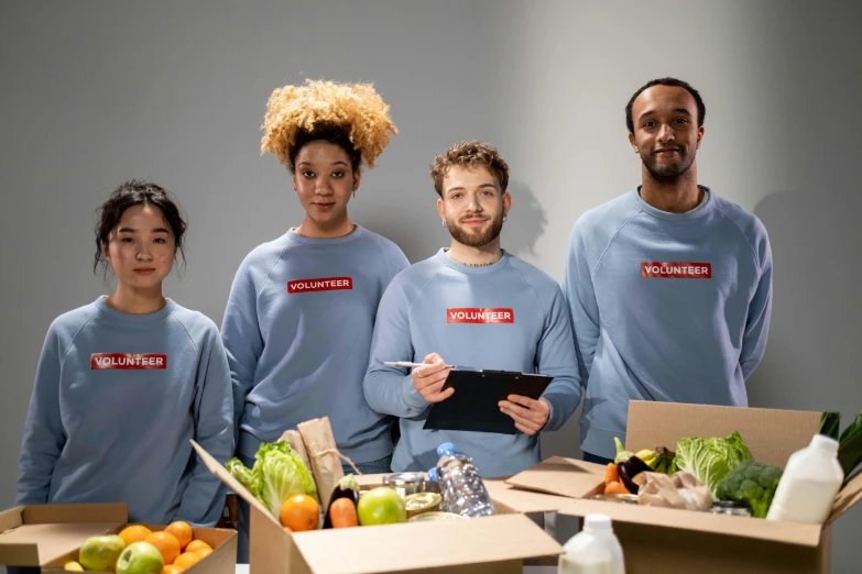 a group of people standing next to boxes of food, commoner, promotional image, thumbnail, humans