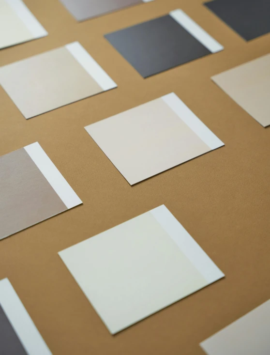 a table topped with lots of different shades of paint, inspired by Frederick Hammersley, trending on unsplash, sandy beige, square sticker, high angle close up shot, monochrome