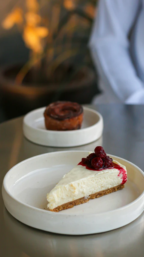 a close up of two plates of food on a table, cakes, manuka, raspberry, woodfired