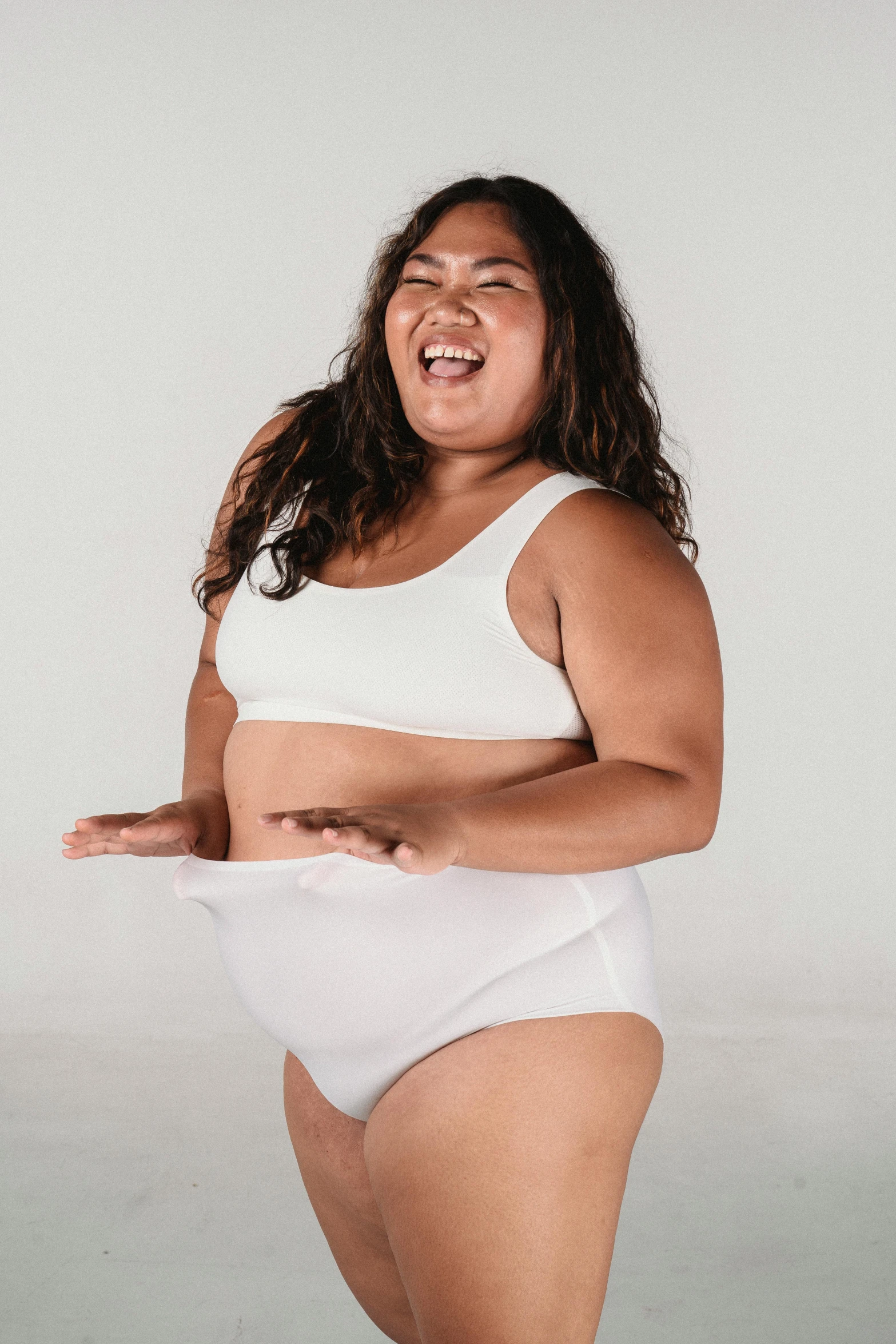 a woman in a white underwear posing for a picture, inspired by Ruth Jên, happening, her belly is fat and round, laughing, promo image, indonesia