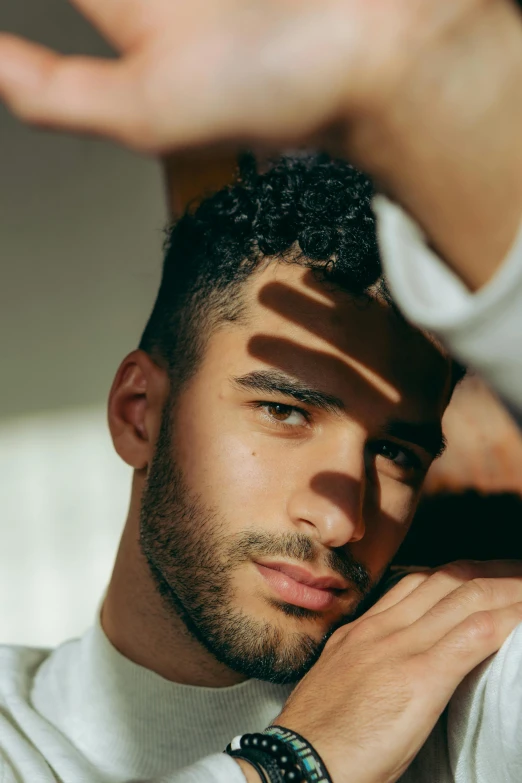 a close up of a person wearing a watch, an album cover, inspired by Alexis Grimou, photorealism, lean man with light tan skin, dappled afternoon sunlight, diverse haircuts, looking straight into camera