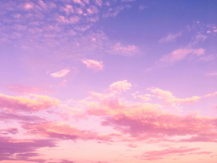 a man riding a surfboard on top of a sandy beach, an album cover, trending on unsplash, aestheticism, fluffy pink anime clouds, panorama view of the sky, violet and pink palette, sunset in the clouds