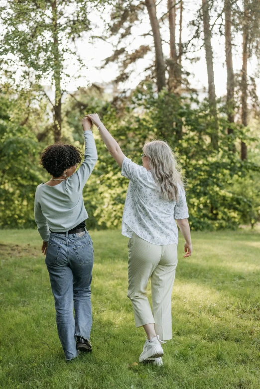 a couple of people that are walking in the grass, two women, reaching out to each other, cottagecore, profile image