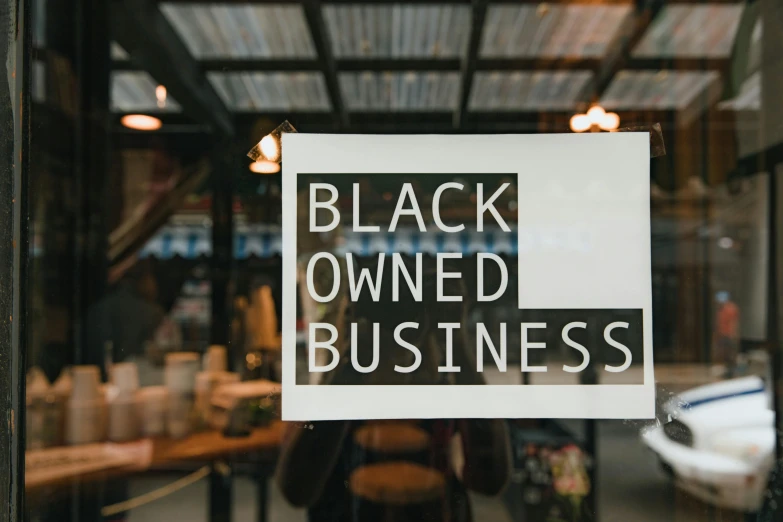 a black owned business sign on a glass door, by Sam Black, trending on unsplash, black arts movement, vantablack, 000 — википедия, brown skinned, etsy