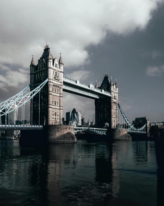 a bridge over a body of water under a cloudy sky, inspired by Thomas Struth, pexels contest winner, tower bridge, album cover, lgbtq, thumbnail