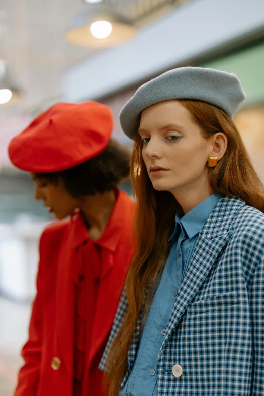 a couple of women standing next to each other, trending on pexels, renaissance, wearing a beret, people shopping, blue or red, wearing a light blue suit