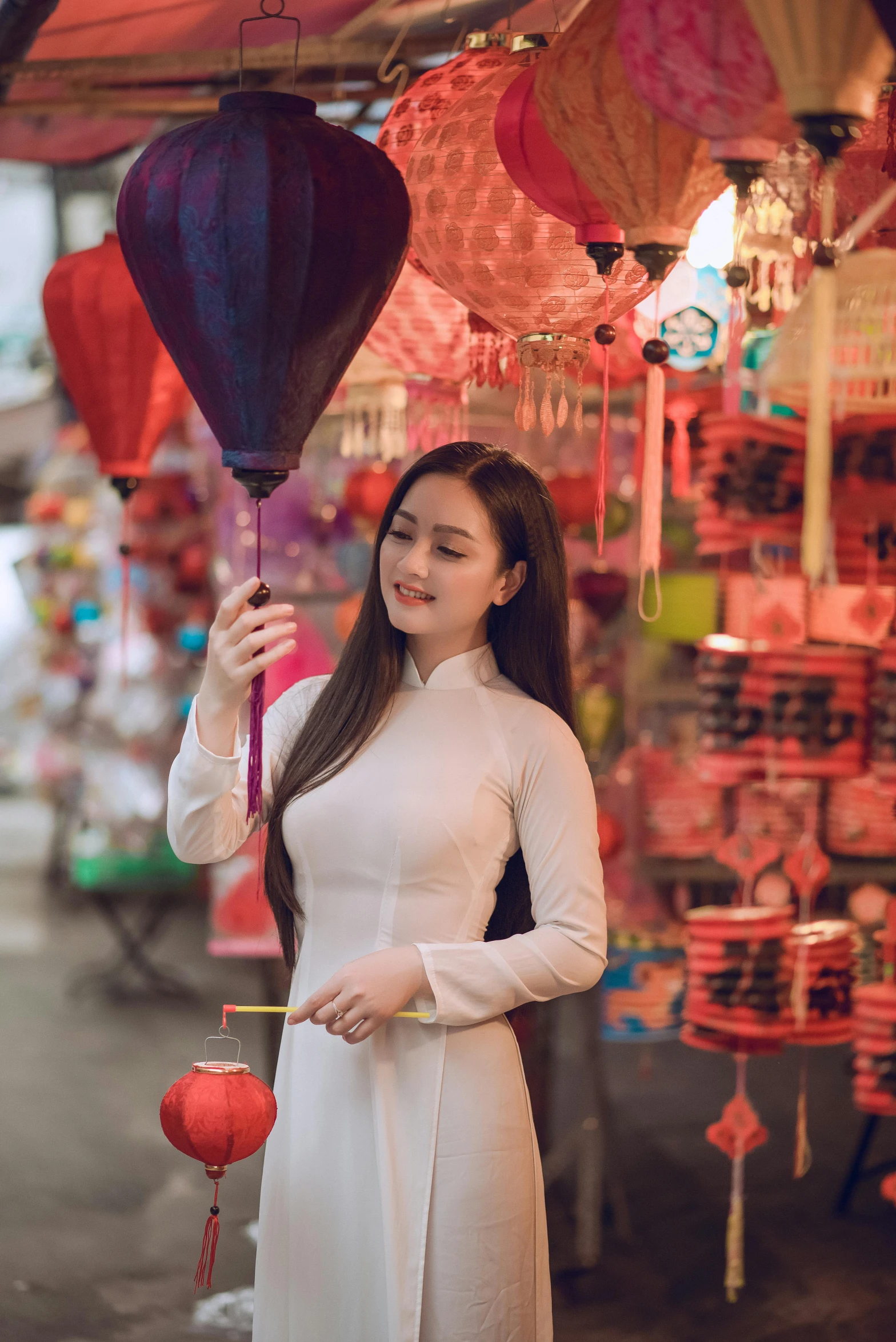 a woman in a white dress holding a red balloon, by Tan Ting-pho, pexels contest winner, happening, market setting, square, hanging lanterns, dilraba dilmurat