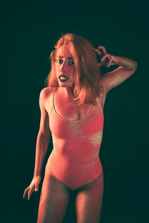 a woman in a pink bodysuit posing for a picture, inspired by Elsa Bleda, film still from a horror movie, maiden with copper hair, square, terrified