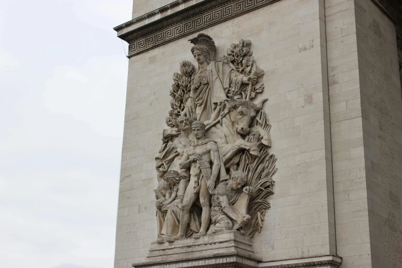 a statue that is on the side of a building, arc de triomphe full of graffiti, dissection relief, ornamentation