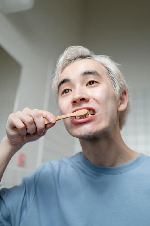 a man brushing his teeth in the bathroom, inspired by Tooth Wu, eating ramen, profile image, gold teeth, graying hair