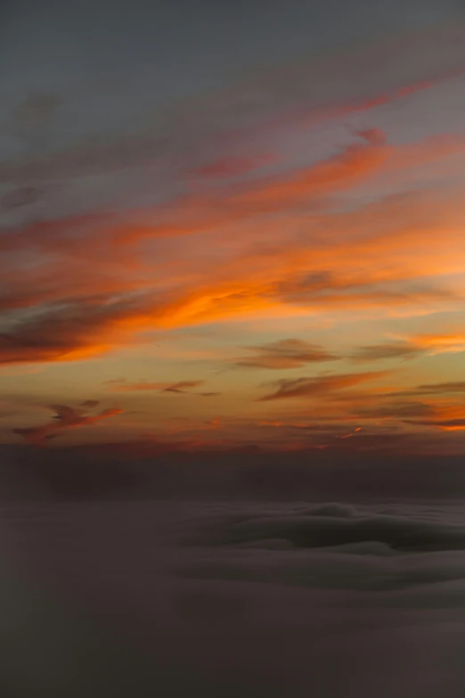 an airplane flying above the clouds at sunset, by Peter Churcher, pexels contest winner, romanticism, layered fog, panorama, today\'s featured photograph 4k, melting clouds