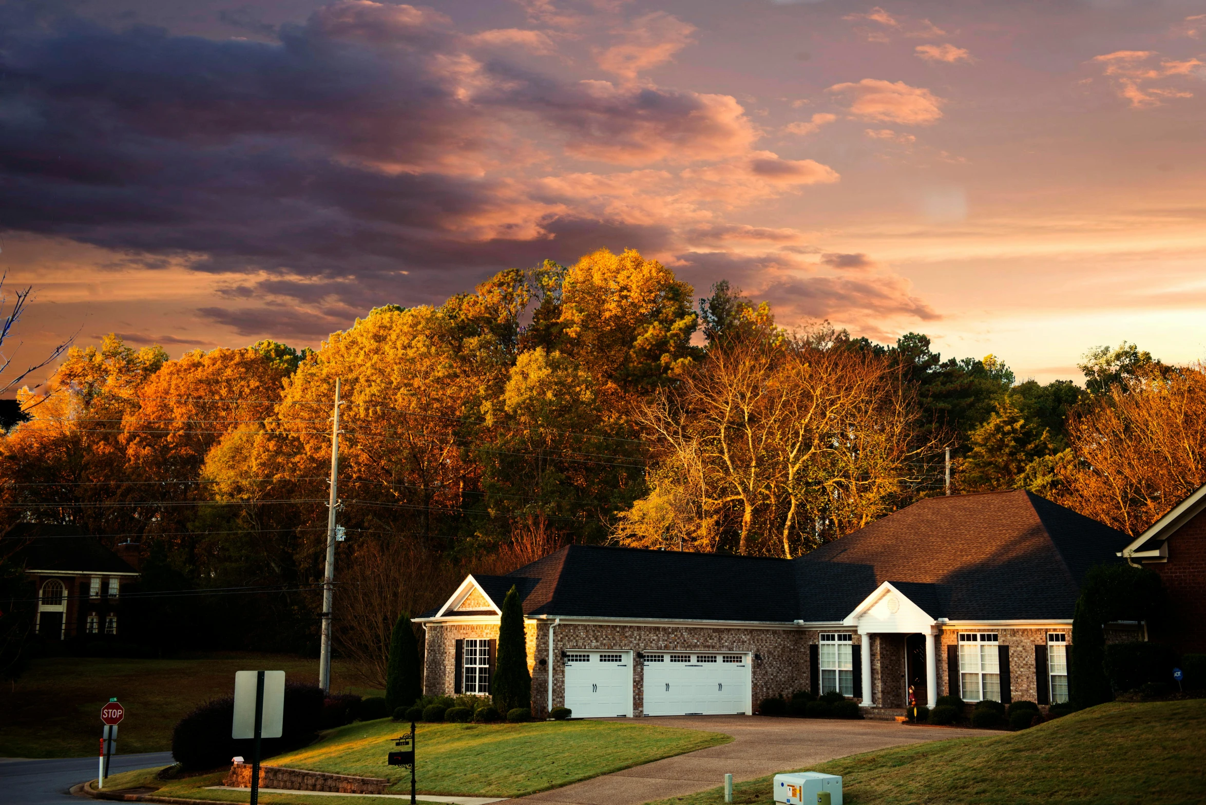 a couple of houses sitting on top of a lush green field, by Carey Morris, pexels contest winner, sunset with falling leaves, suburban home, panoramic shot, 1 6 x 1 6