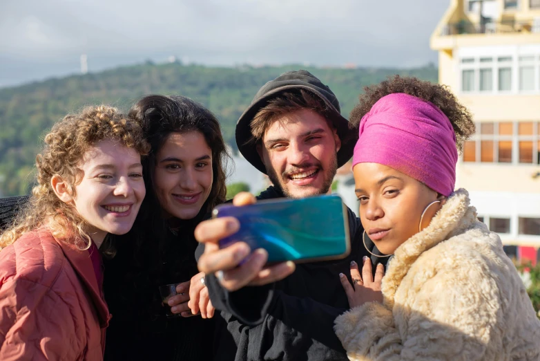 a group of people taking a picture with a cell phone, aida muluneh, gen z, movie filmstill, nice face