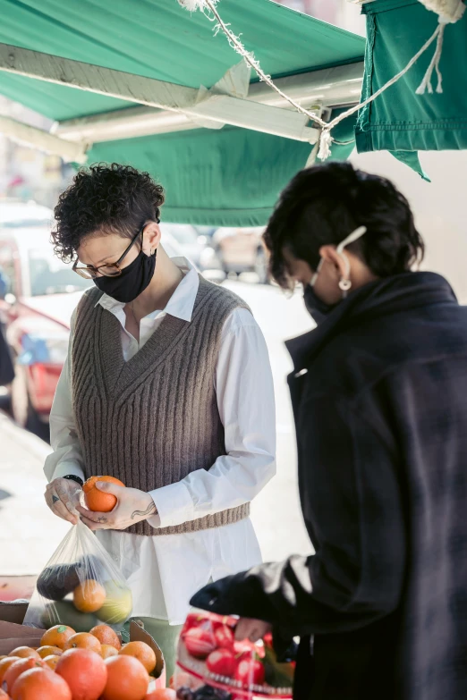 a group of people standing around a fruit stand, orange balaclava, zachary corzine, square, 4l