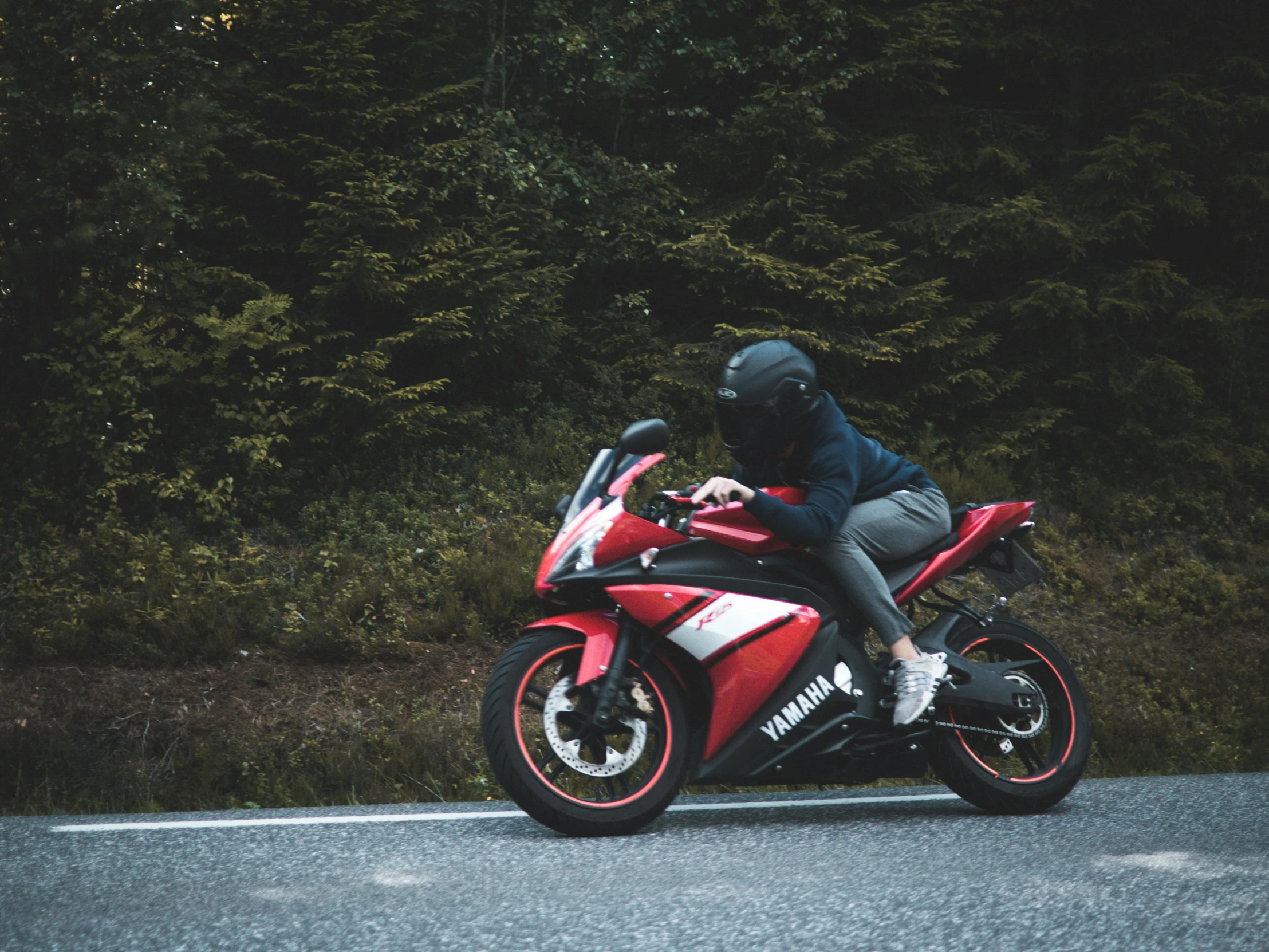 a man riding on the back of a red motorcycle, pexels contest winner, wearing her helmet, crouching, avatar image, no cropping