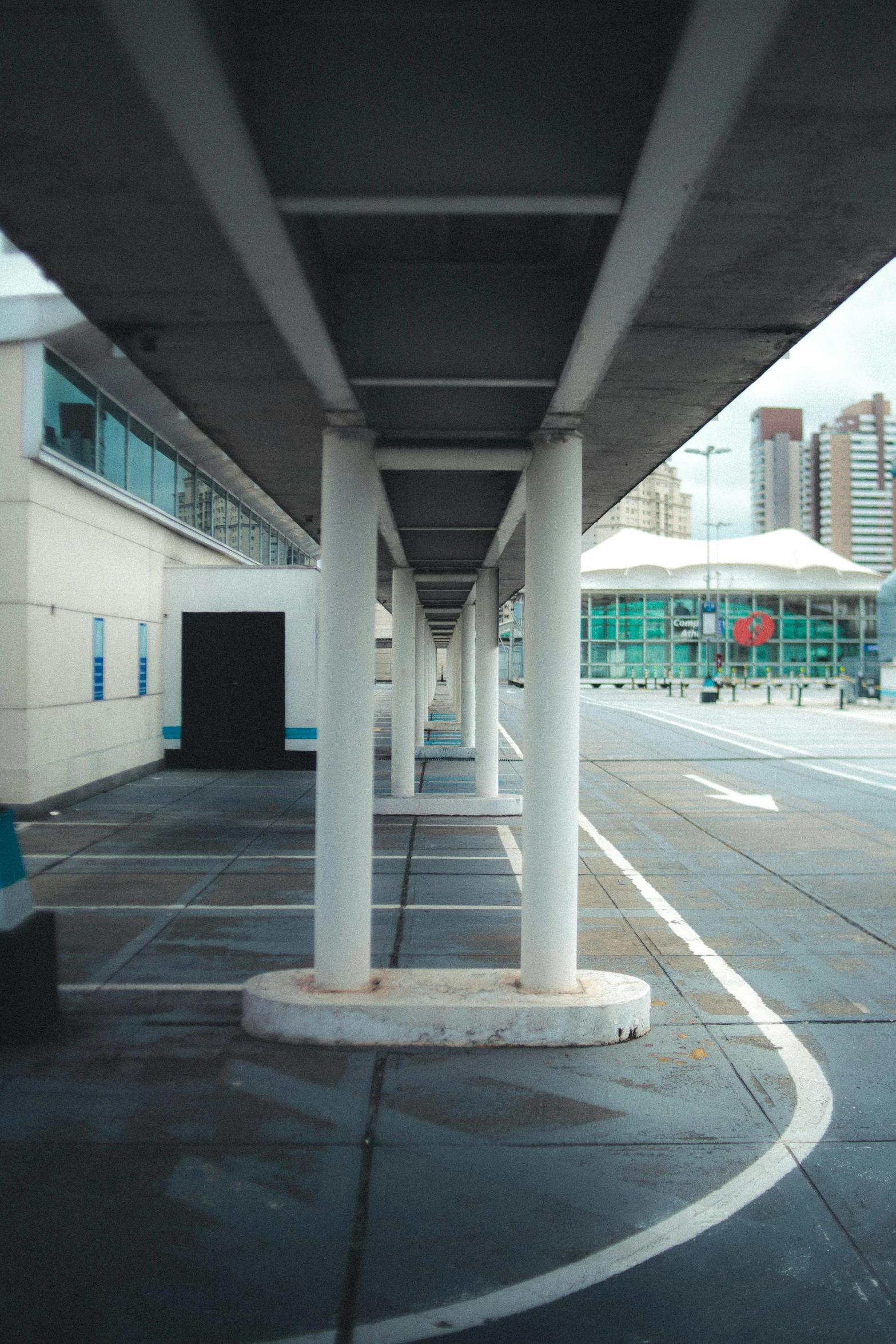 an empty parking lot with buildings in the background, an album cover, inspired by Robert Bechtle, unsplash, temporary art, monorail station, canopies, in hong kong, empty stools