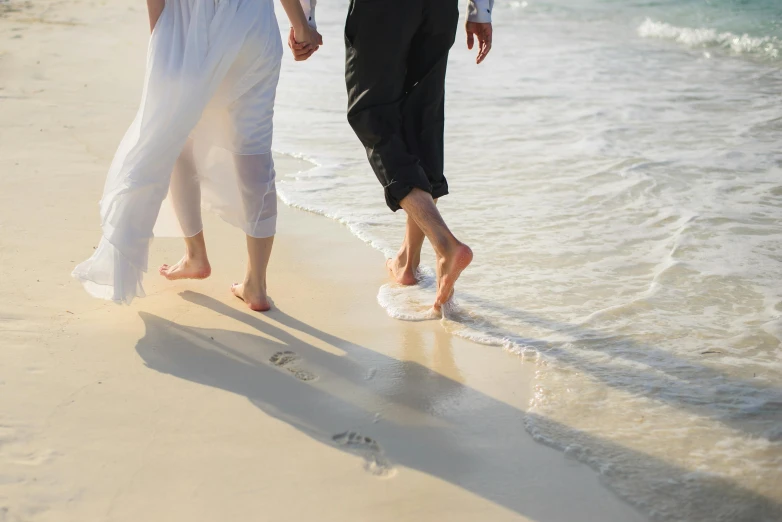 a man and a woman walking on a beach, by Arabella Rankin, pexels, elegant feet, wedding, treading on calm water, 15081959 21121991 01012000 4k