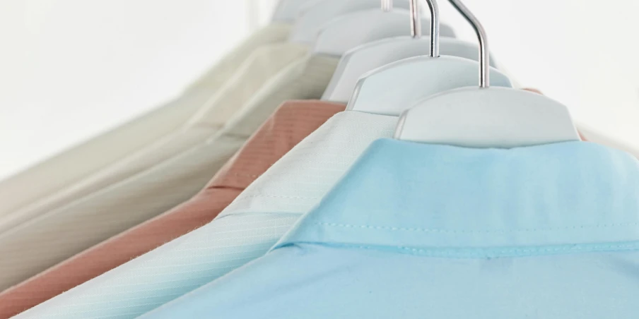 a row of shirts hanging on a clothes rack, by Julian Allen, pastell colours, thumbnail, superior detail, edge to edge