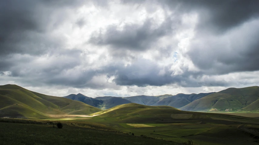 a herd of cattle grazing on a lush green hillside, by Muggur, pexels contest winner, renaissance, giant clouds, distant mountains lights photo, panoramic view, fan favorite