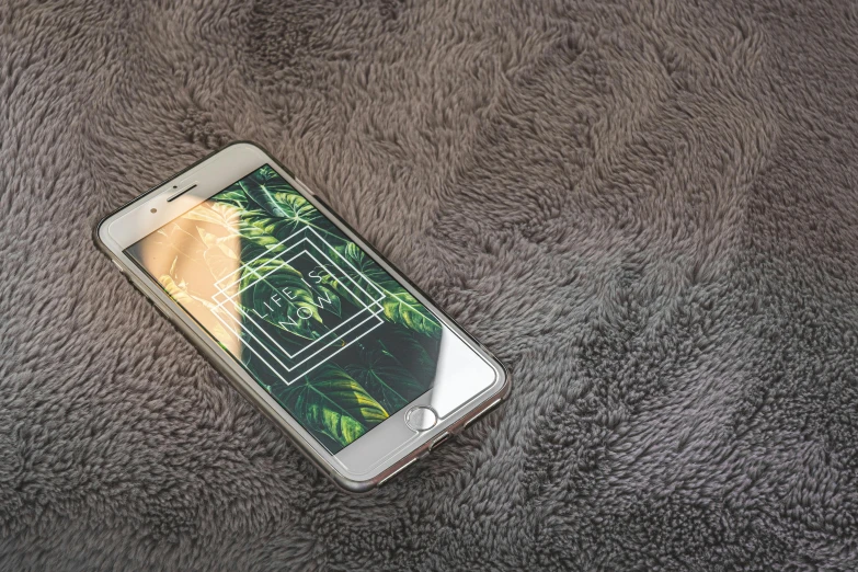 a close up of a cell phone on a blanket, a picture, trending on pexels, 3d parallax view effect, leaves and simple cloth, 4 k hd wallpapear, high angle