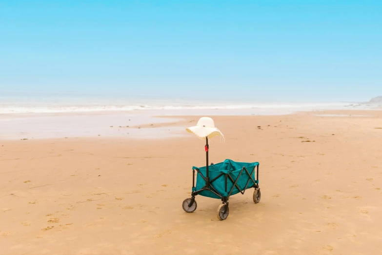 a blue cart sitting on top of a sandy beach, pexels contest winner, conceptual art, seafoam green, omaha beach, long view, profile image