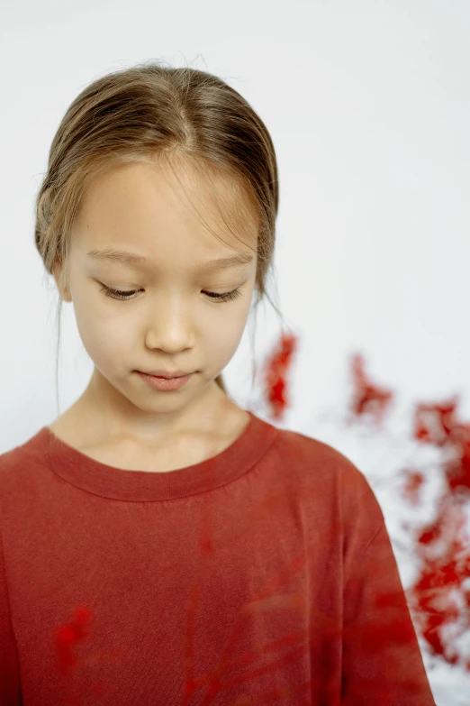 a little girl standing in front of a bunch of red berries, inspired by Xia Shuwen, visual art, blood stains on shirt, pouty, close - up photograph, uncropped