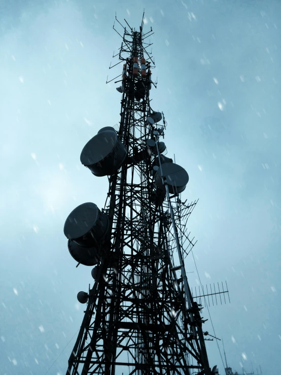 a tall tower sitting in the middle of a snow covered field, pexels, satellite dishes, while it's raining, against dark background, background image