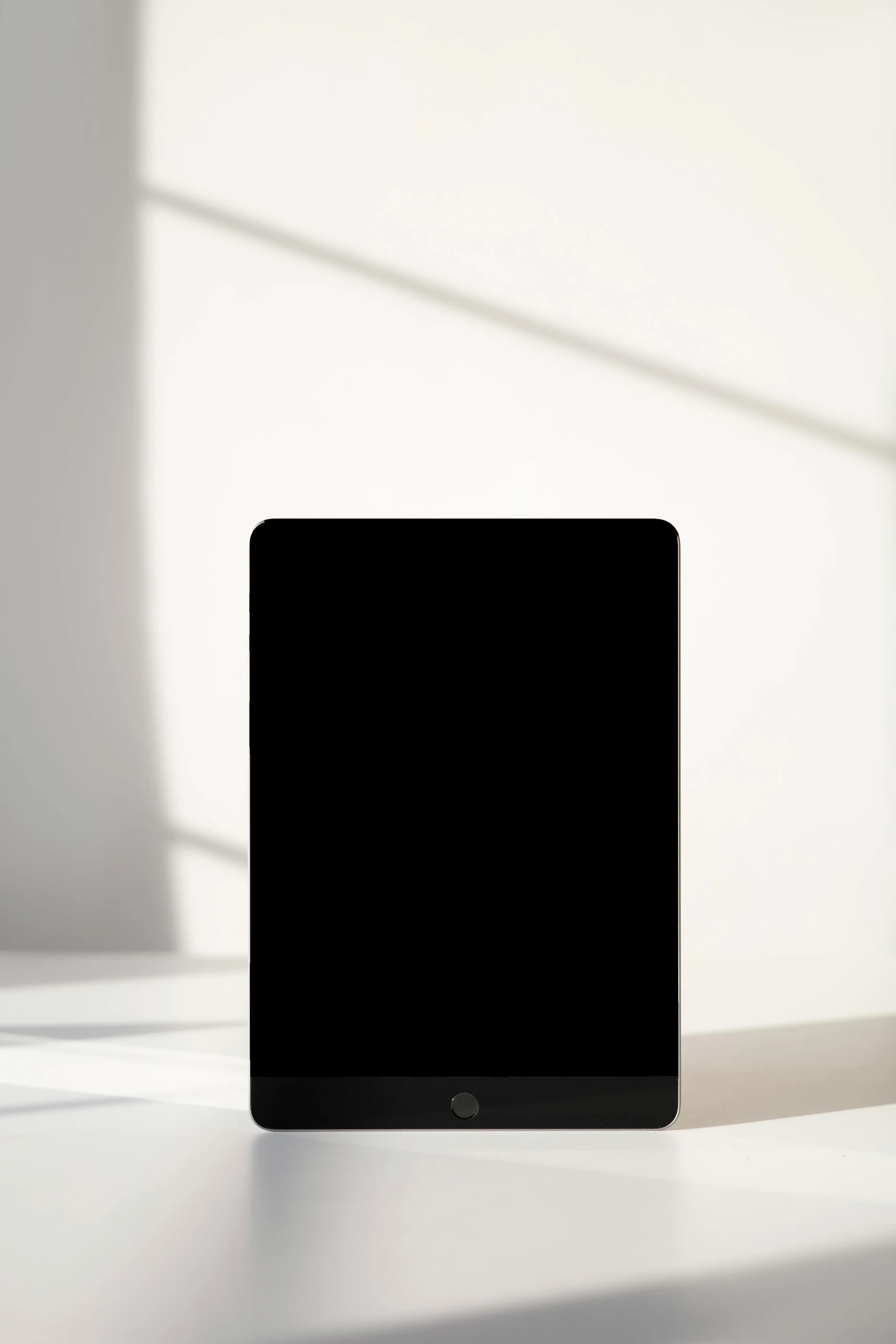 a laptop computer sitting on top of a white desk, vantablack wall, ipad pro, ignant, suns