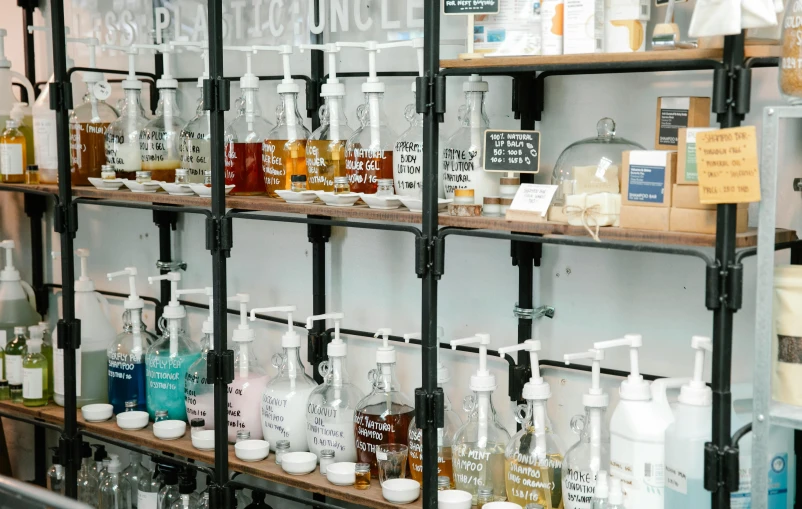 a bunch of bottles that are on a shelf, trending on unsplash, lush, in a lab, dezeen showroom, thumbnail