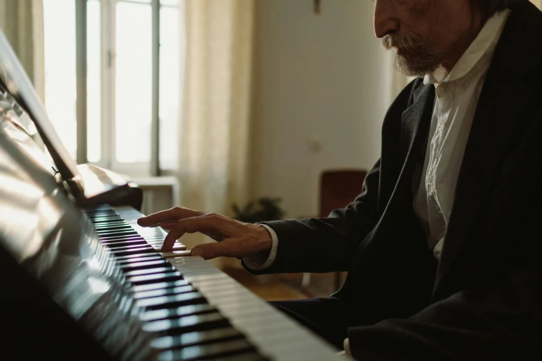 a man in a suit playing a piano, unsplash, an oldman, ignant, still from l'estate, fan favorite