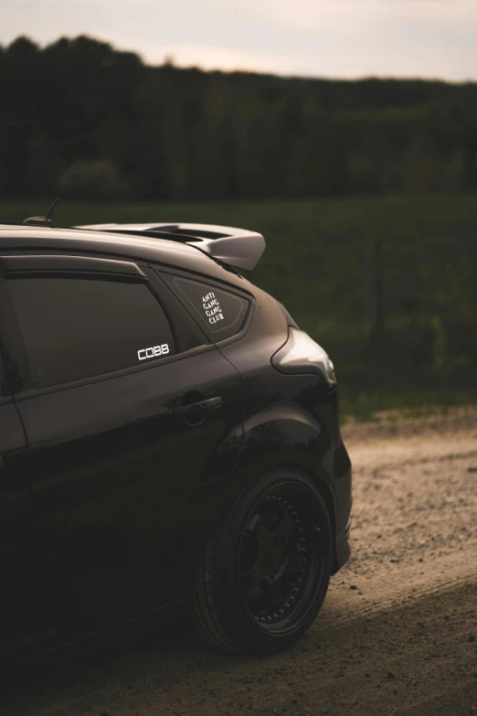 a car parked on the side of a dirt road, by Chris Rallis, unsplash, close - up profile, matte black paper, rally car, backlighted