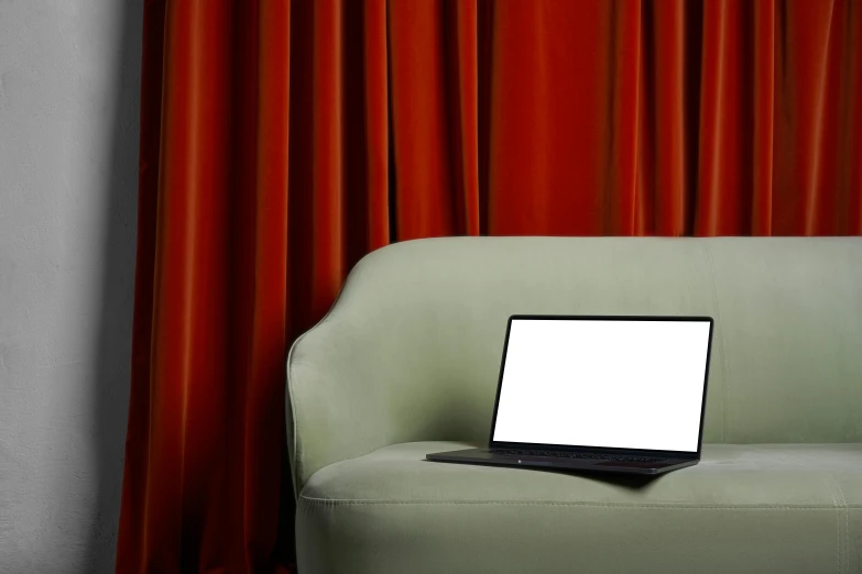 a laptop computer sitting on top of a green chair, inspired by Elsa Bleda, computer art, red curtain, sofa, theatrical, curtain