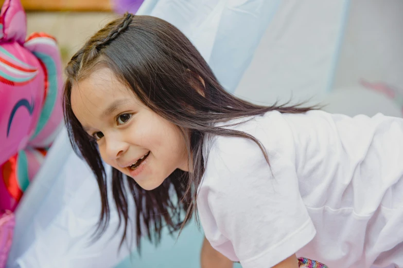 a little girl standing on top of a bed next to a stuffed animal, a child's drawing, by Pablo Carpio, pexels contest winner, smiling down from above, girl with angel wings, softplay, asian girl with long hair