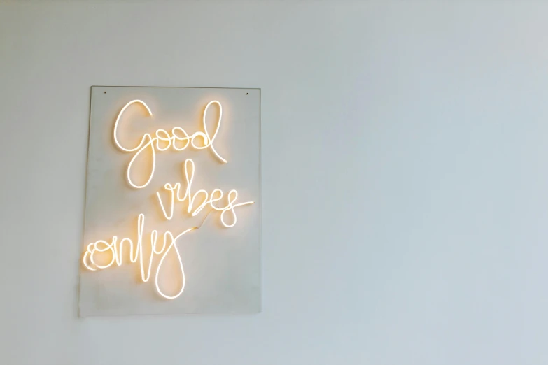 a close up of a neon sign on a wall, trending on pexels, minimalism, in a white boho style studio, weekly, living the good life, studio ghibly style
