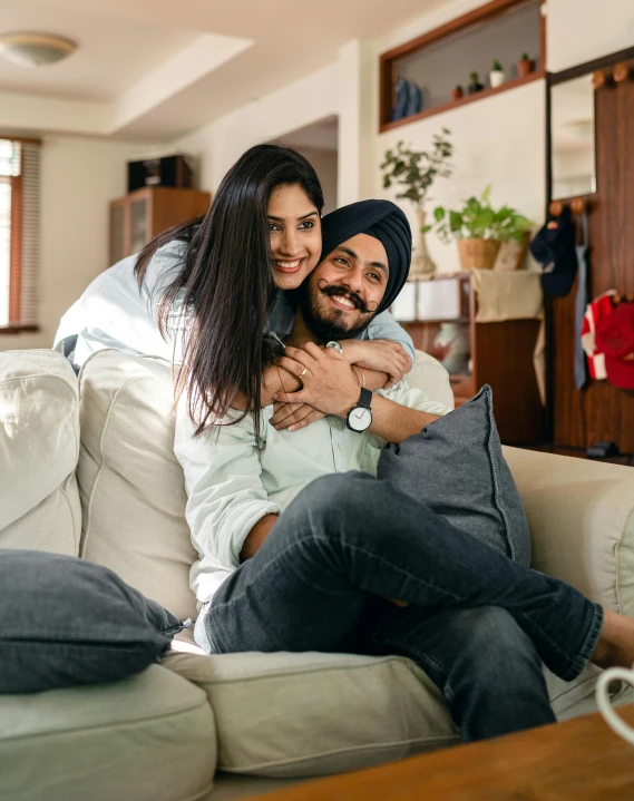 a man and a woman sitting on a couch, inspired by Manjit Bawa, pexels contest winner, happening, hugging, proud looking, thumbnail, indoor picture