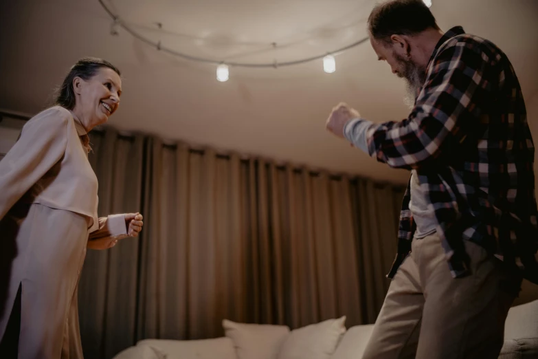 a man and a woman playing a video game, a hologram, by Emma Andijewska, pexels contest winner, happening, line dancing at a party, couple on bed, joyful people in the house, ring lighting