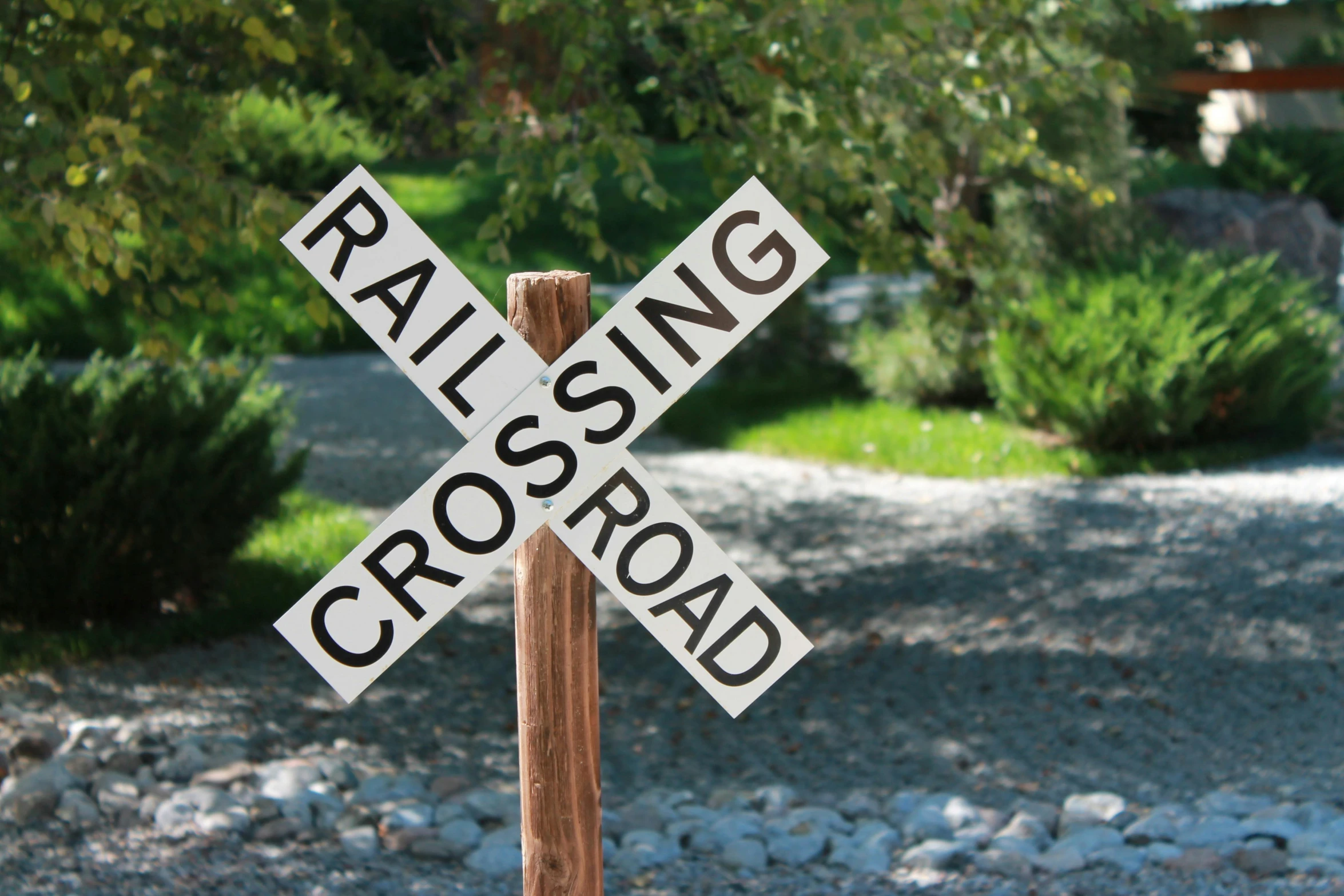 a railroad crossing sign sitting on the side of a road, profile image, square, decoration, outdoor